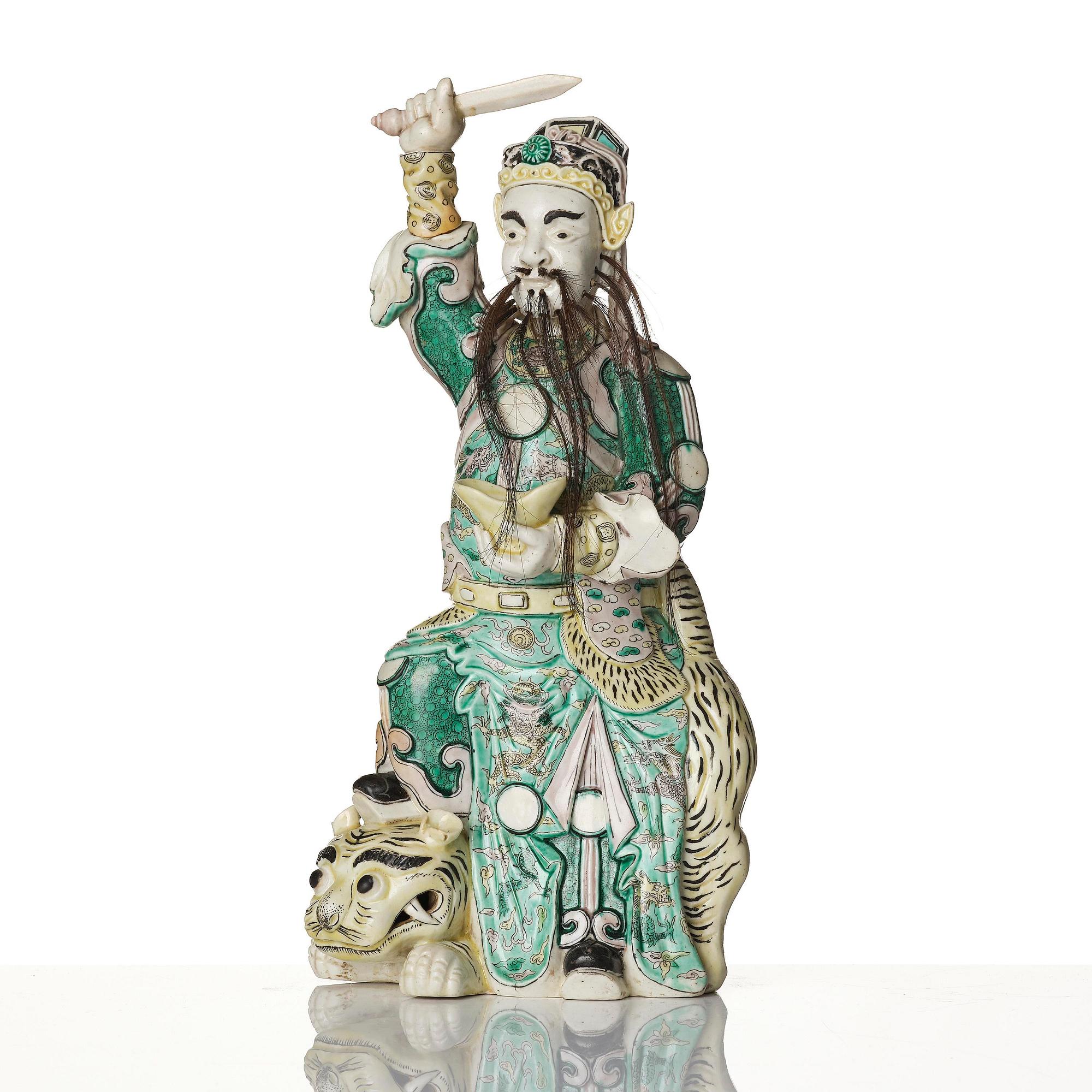 A famille verte bisquit figure of a warrior, Qing dynasty, 19th century.
