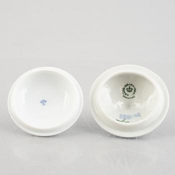 Two 'Blue Fluted' / 'Musselmalet rifflet' porcelain cream cups with covers, Royal Copenhagen, 19th century and 1964.