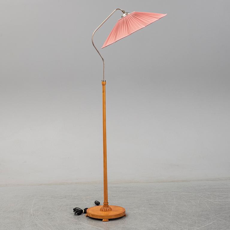 A 1940s birch wood floor lamp.