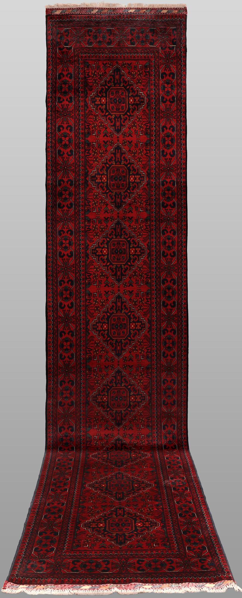 A Afghan runner carpet, 388 x 79 cm.