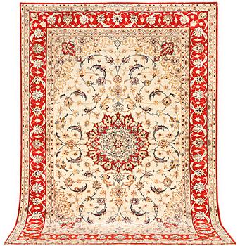 A semi-antique part silk Isfahan rug, a. 238 x 156 cm.