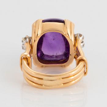 A WA Bolin ring in 18K gold set with a cabochon-cut amethyst and round brilliant-cut diamonds.