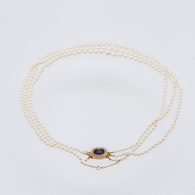 Necklace with three rows of cultured pearls and a clasp in 18K gold.