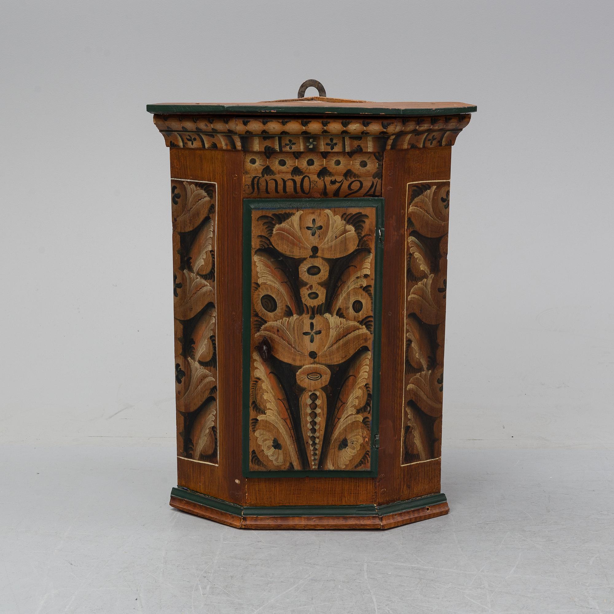 A painted corner cabinet, dated 1794.