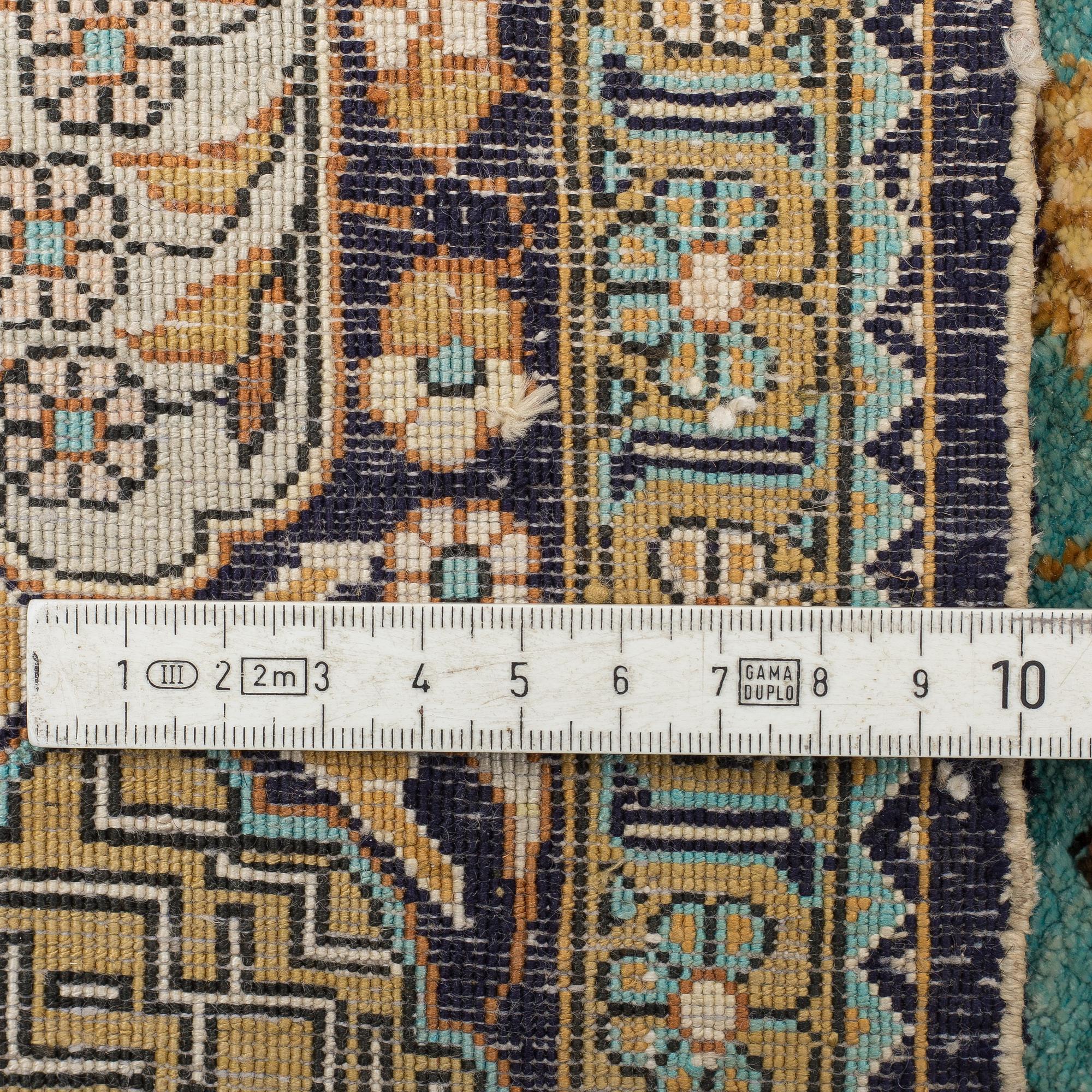 A RUG, an old silk Qum figural, ca 154,5 x 107,5 cm.