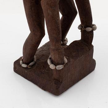 A group of three wooden Asmat sculptures, 20th Century.