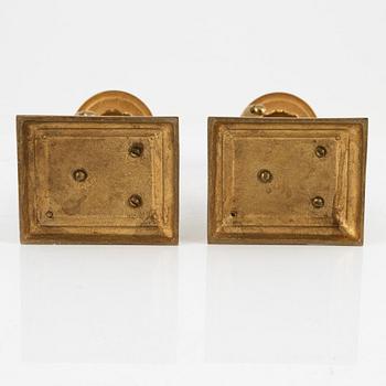 A pair of brass candleholders, 20th century.