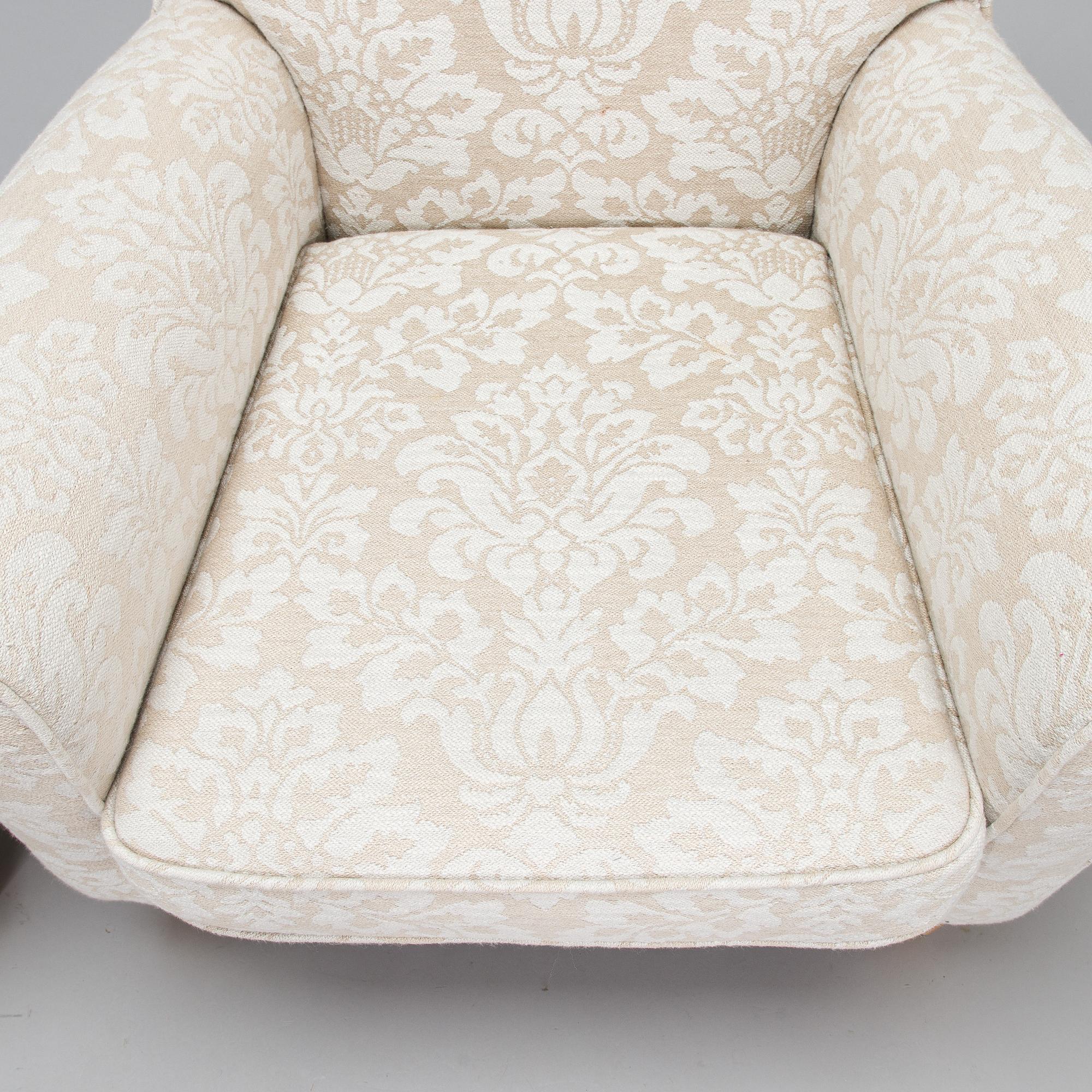A mid-20th-century armchair and ottoman.