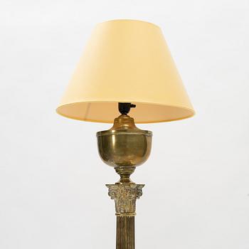 A brass floor lamp, circa 1900.