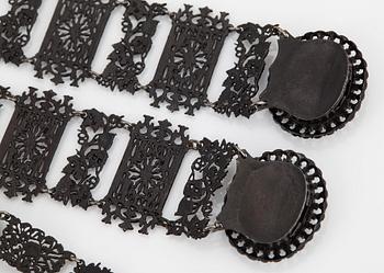 A Berlin steel and iron parure comprising a necklace, two bracelets and a brooch.