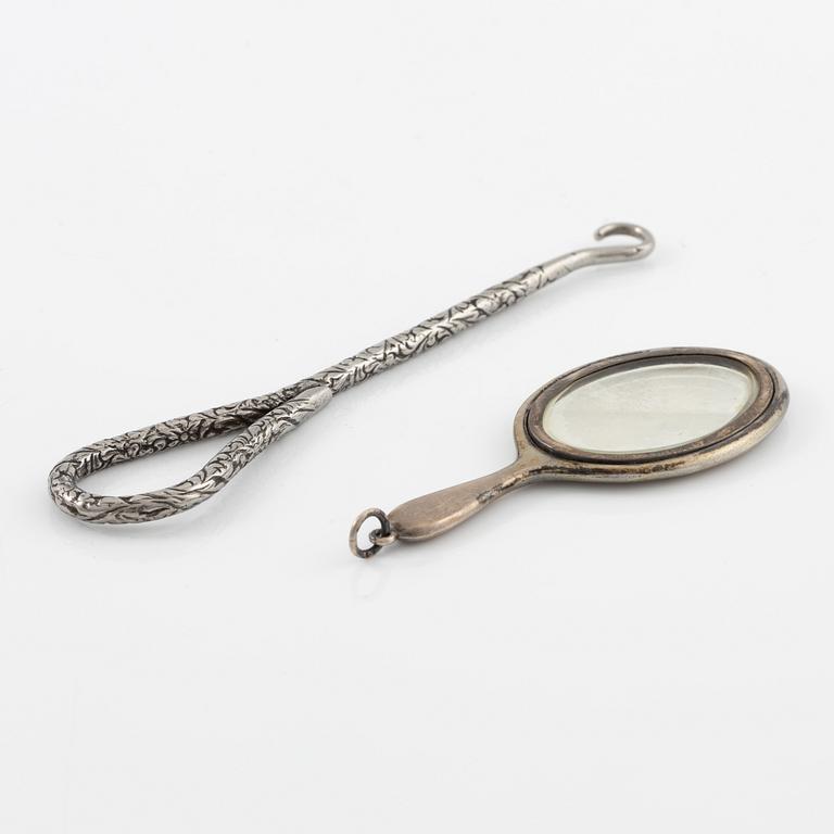 Two brushes, a hook, and a small mirror, silver and nickel silver.