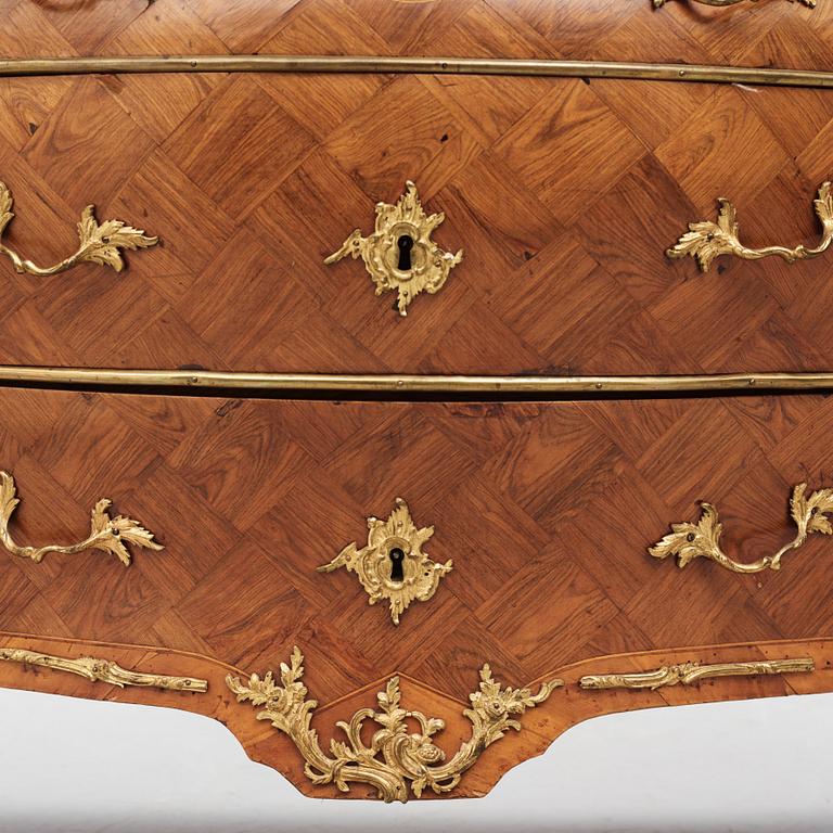 A rococo parquetry and gilt brass-mounted commode by J. J. Eisenbletter (active ca 1760-1810).