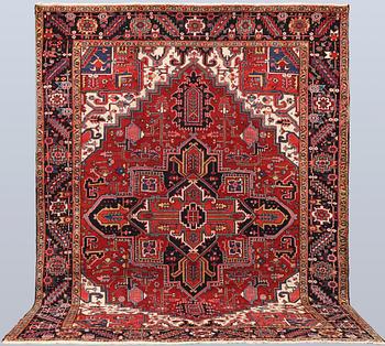 A semi-antique Heris carpet, approx. 343 x 260 cm.