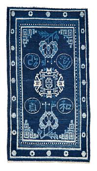 225. A RUG, a semi-antique Xinjiang (Sinkiang), China, ca 127 x 67-69 cm (as well as one end with ca 1 cm flat weave).