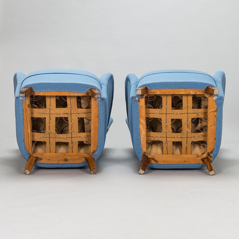 A pair of mid-20th-century armchairs.