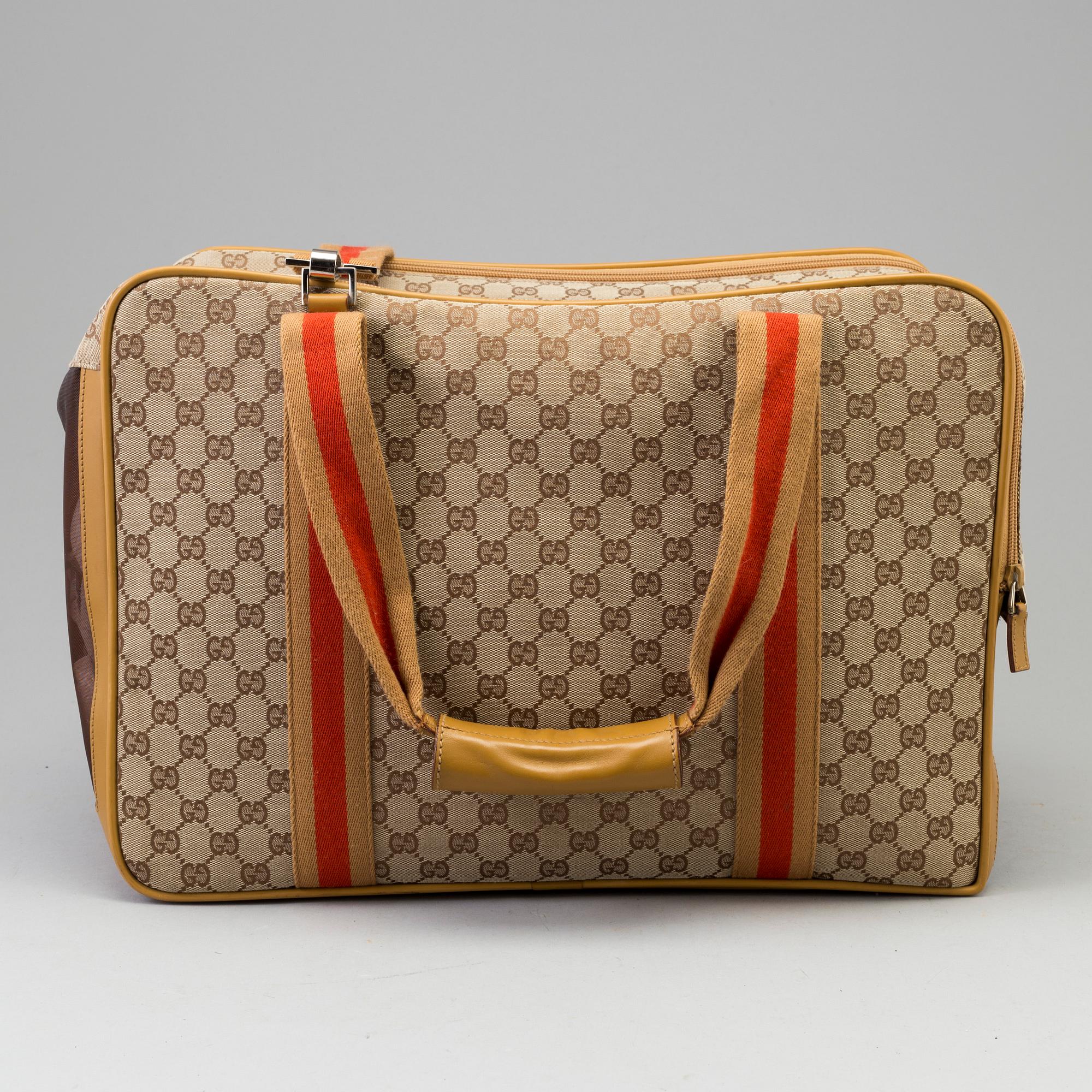 GUCCI, a monogram canvas dog bag.