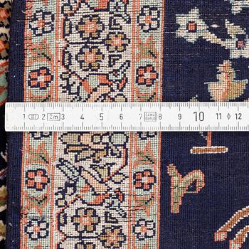 A silk Ghom rug, c. 94 x 62 cm.