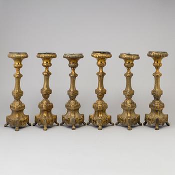 Six late 18th century brass candlesticks.