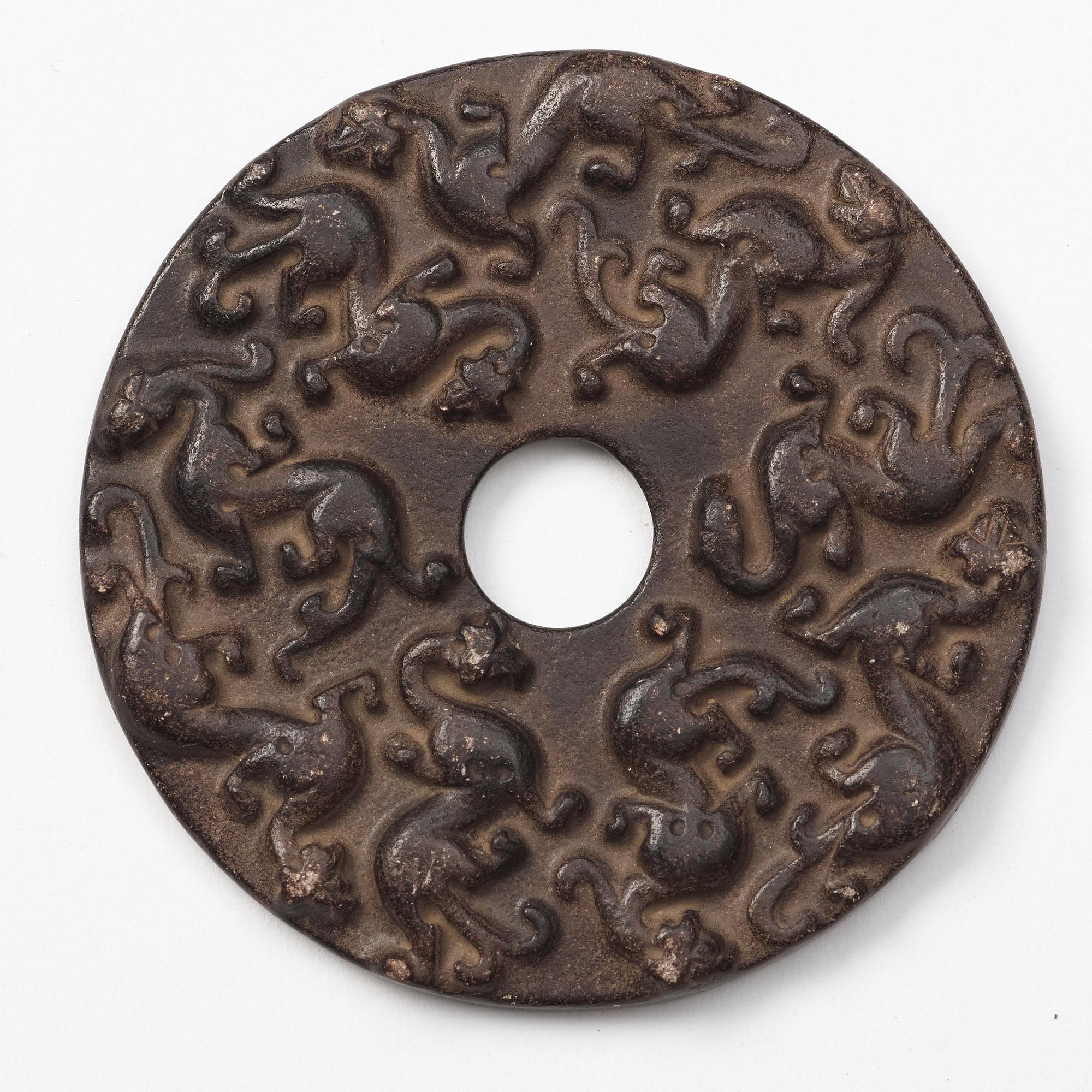 A group of three archaistic Chinese stone bi discs and two pendants.