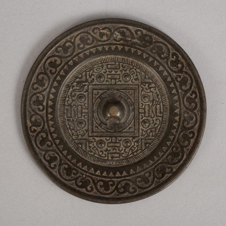 A bronze mirror, Xin-Eastern Han dynasty (9-220).