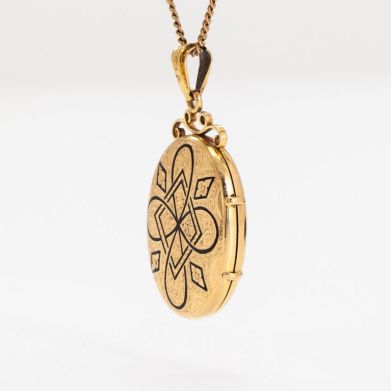 An 18K gold locket pendant, with chain in 14K gold.