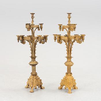 Two similar 19th century bronze candelabras.
