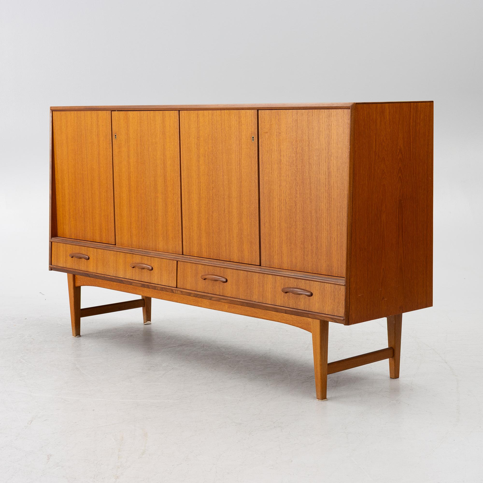 A mid20th century teak-veneered sideboard.
