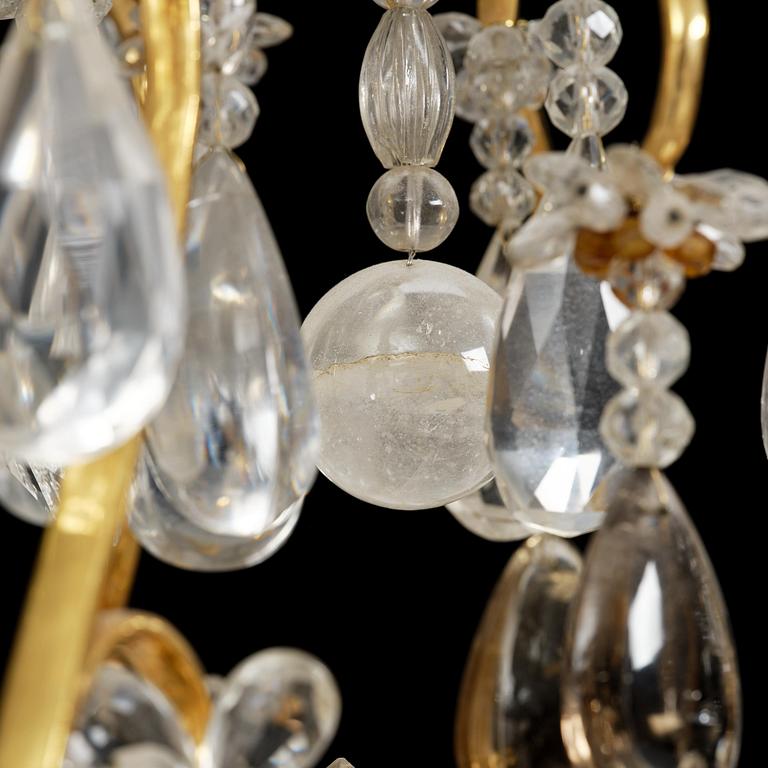 A near pair of Franch Louis-XV-style nine-branch gilt bronze and rock crystal chandeliers, later part 19th century.