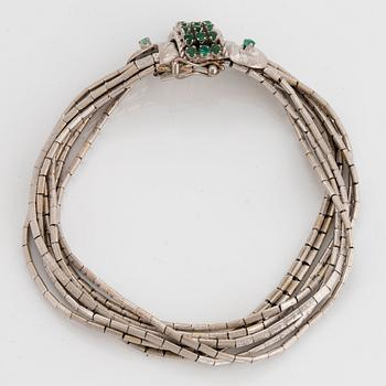 An 18K white gold bracelet set with faceted emeralds.