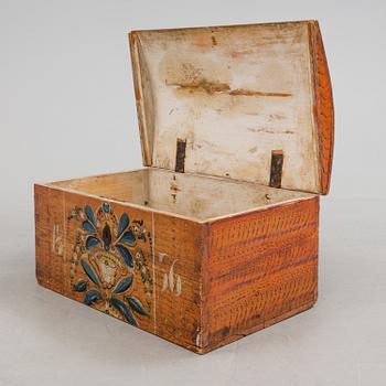 A wooden chest, dated 1856.