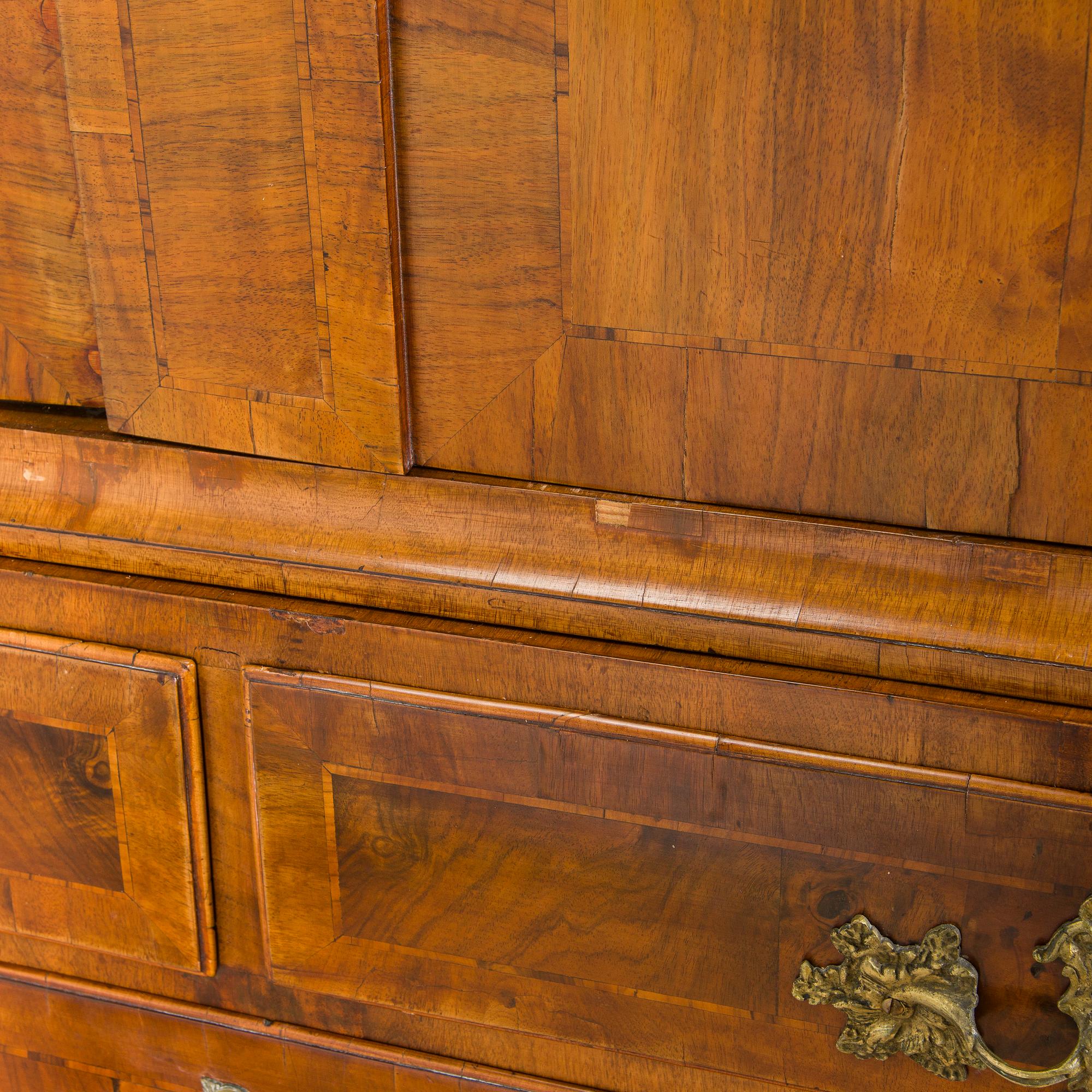 A Swedish walnut-veneered rococo cabinet in the manner of C. Linning, latter half of the 18th Century.