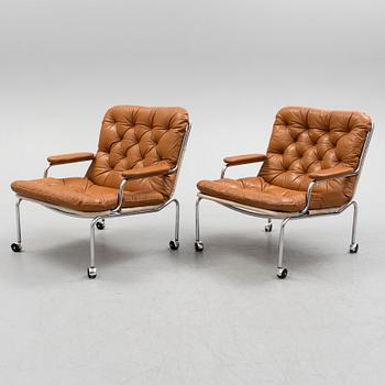 A pair of leather upholstered easy chairs, 1960's/70's.