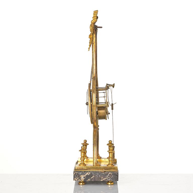 A French Louis XVI ormolu and marble lyre-shaped mantel clock, late 18th century.