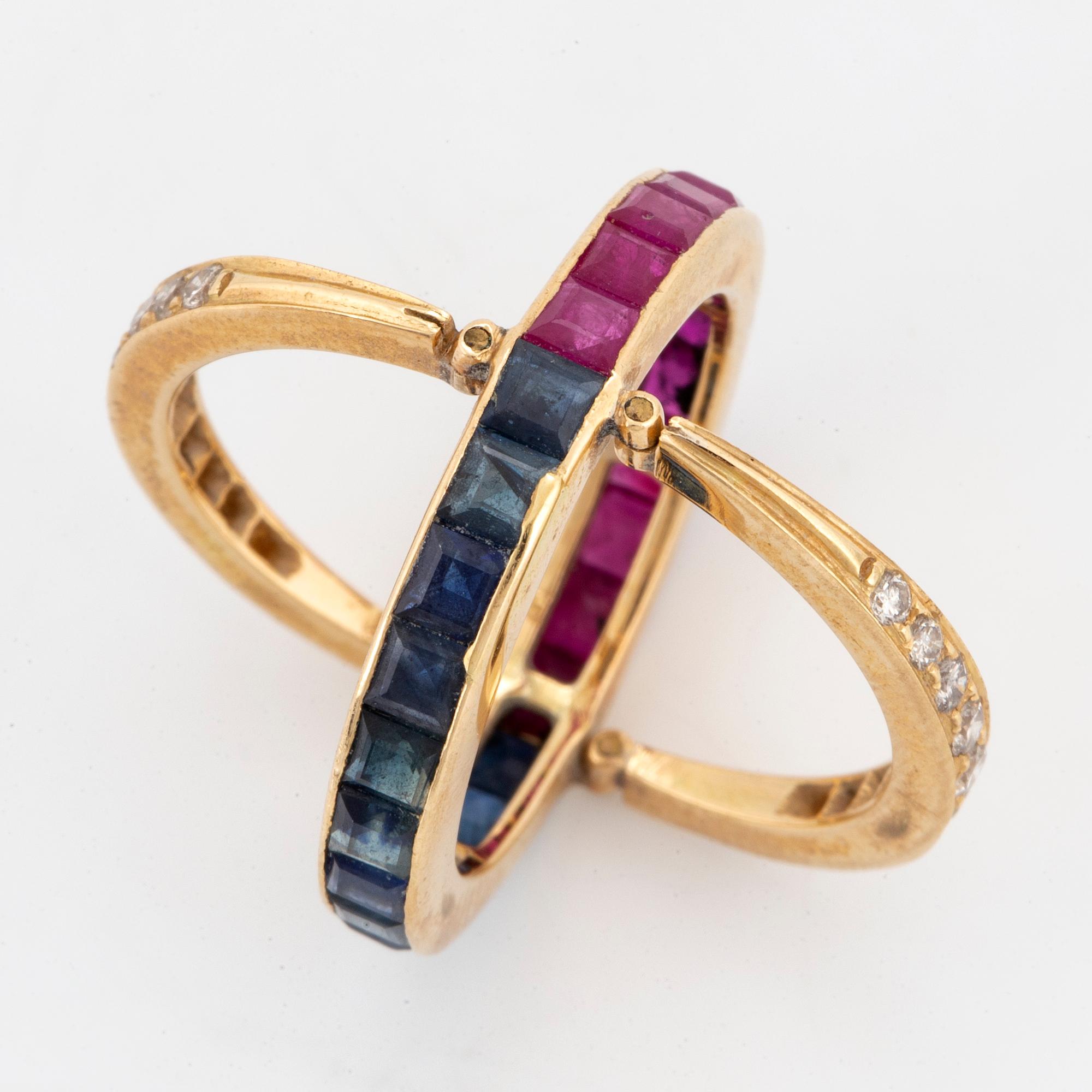Calibre-cut ruby and sapphire and brillint-cut diamond ring.