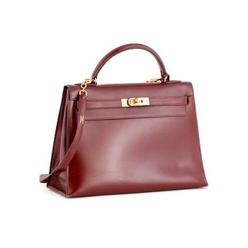 HERMÈS, a burgundy red leather handbag, "Kelly 32".