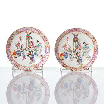 A pair of famille rose 'figural' tea cups with saucers, Qing dynasty, Qianlong (1736-95).