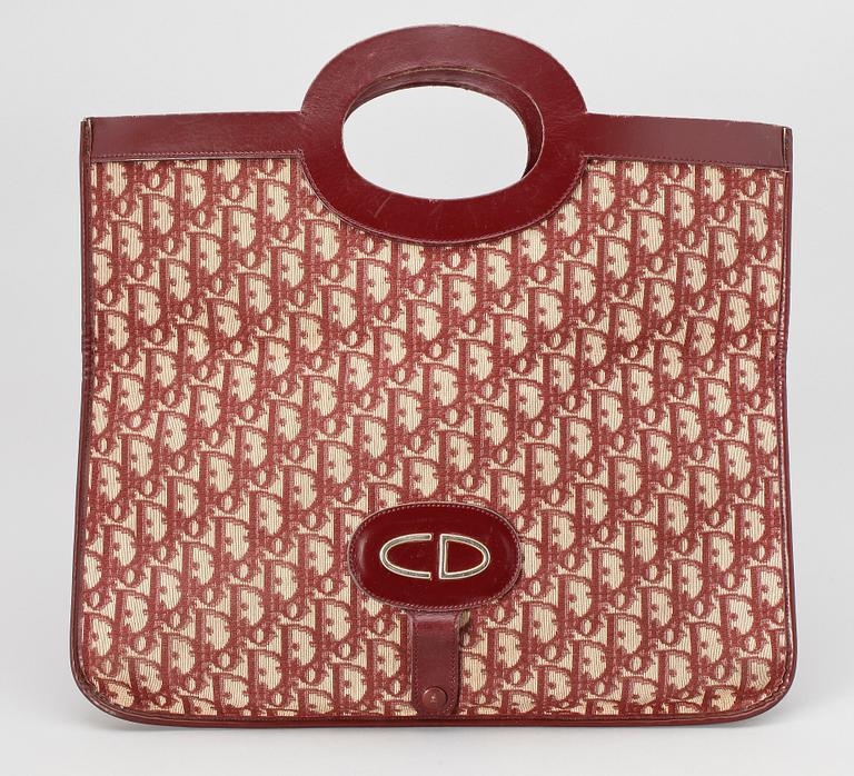 A red monogram canvas handbag by Christian Dior.