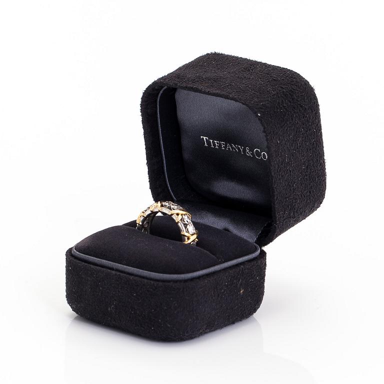 Tiffany & Co, a platinum and 18K gold 'Schlumberger' ring, with brilliant-cut diamonds.