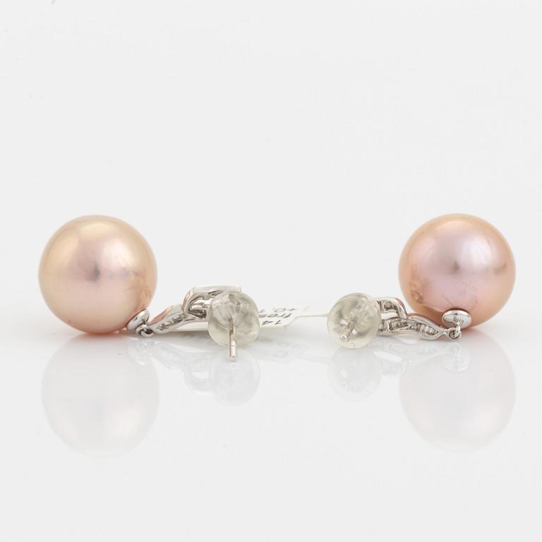 Pink freshwater pearl and baguette diamond earrings.