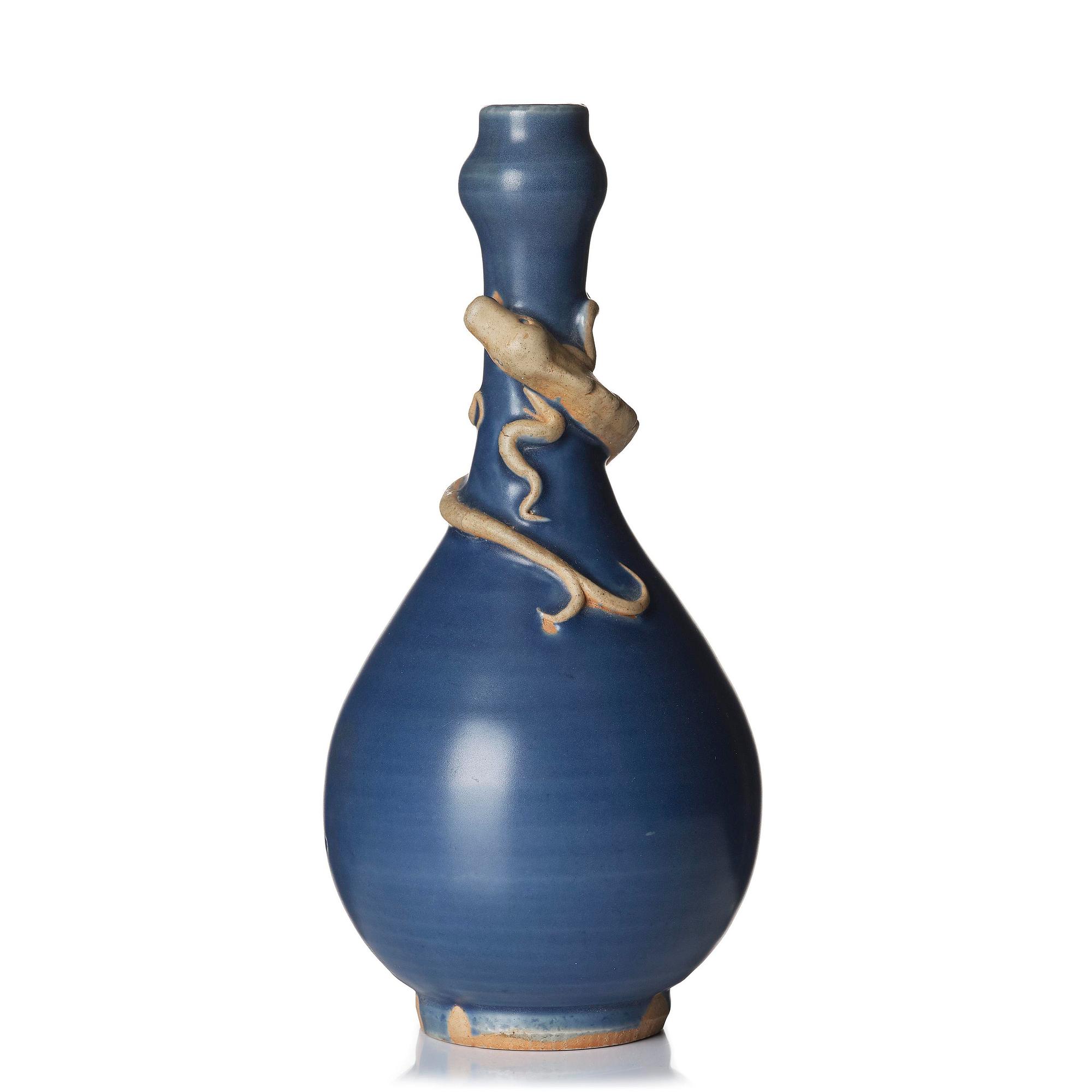 A blue glazed vase with a dragon in relief, late Ming dynasty/early Qing dynasty.