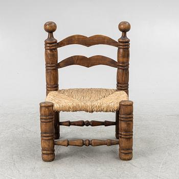Charles Dudouyt, attributed to, a fireside low chair, mid 20th century.