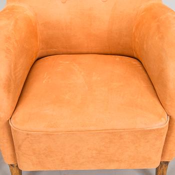 A pair of mid-20th century armchairs.