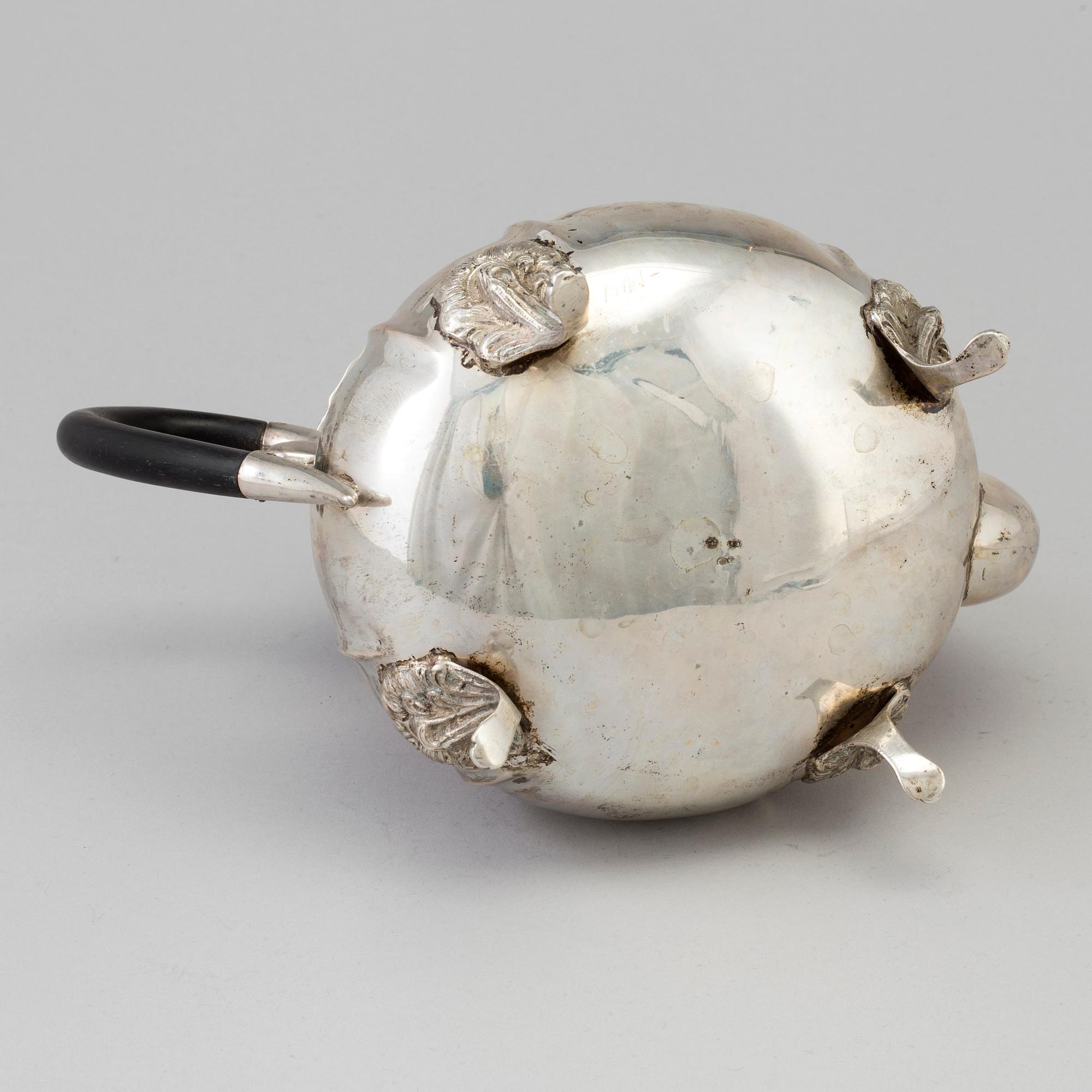 A silver rococo style teapot.