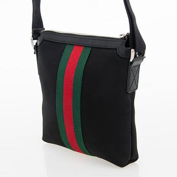 Gucci, a "Techno Canvas Web Messenger" bag.