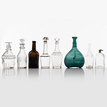 A set of eight glass bottles and decanters, circa 1800/19th Century.