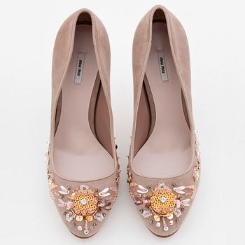 MIU MIU, a pair of beige suede pumps with sequined embellishment.