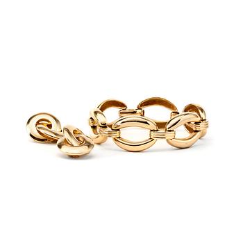 595. CHRISTIAN DIOR, a gold colored bracelet and clips earrings.