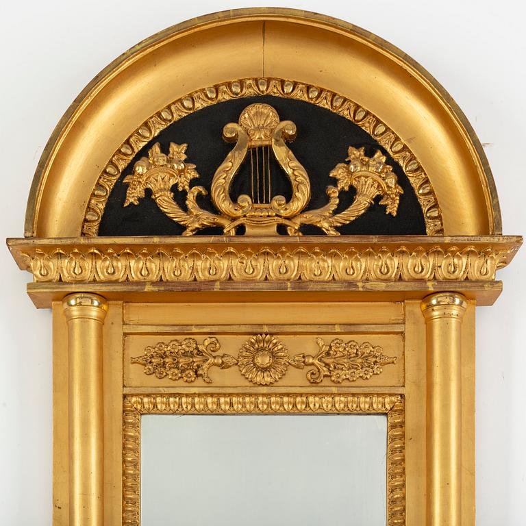 A 20th century Empire style gilt mirror.