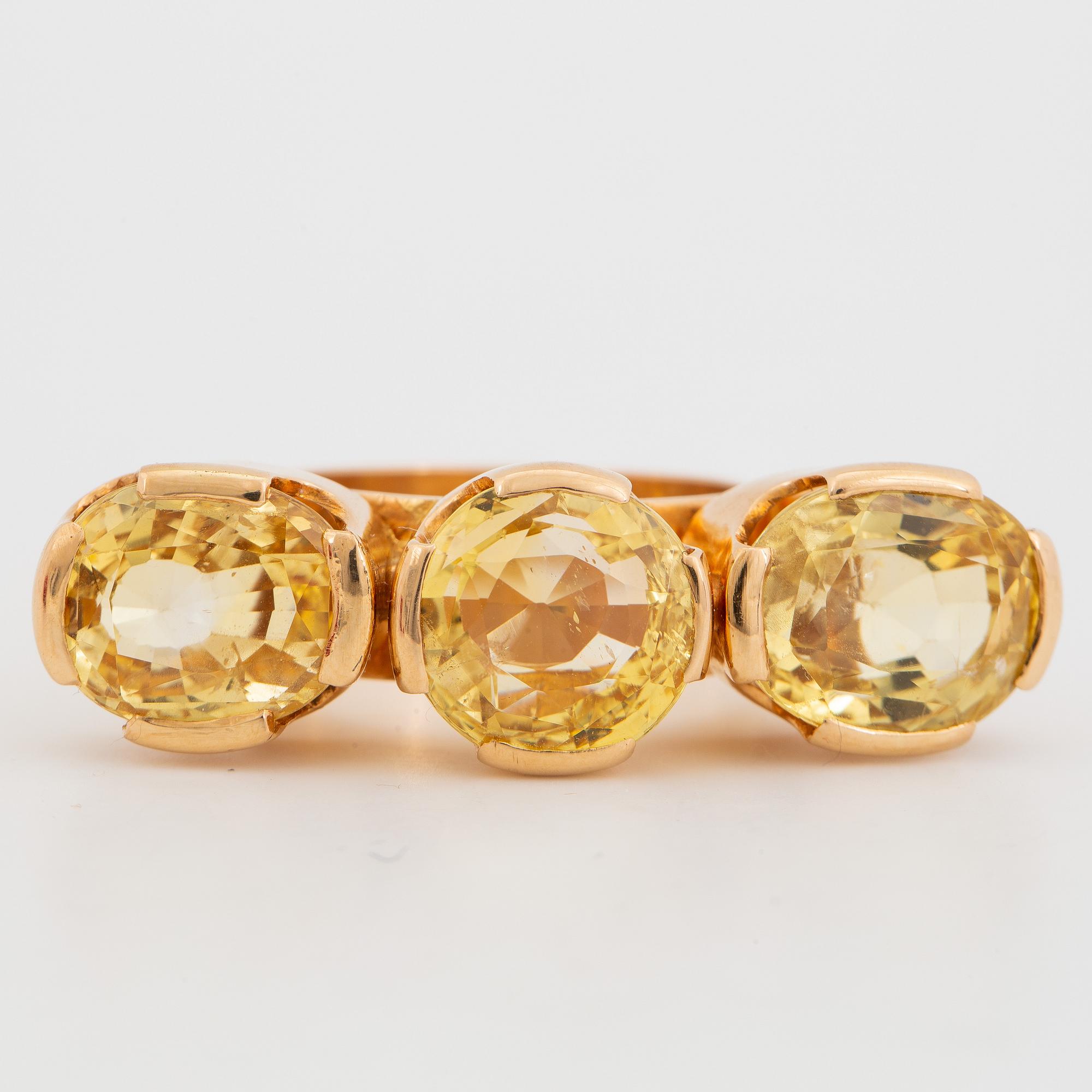 18K gold and yellow sapphire three-stone ring.