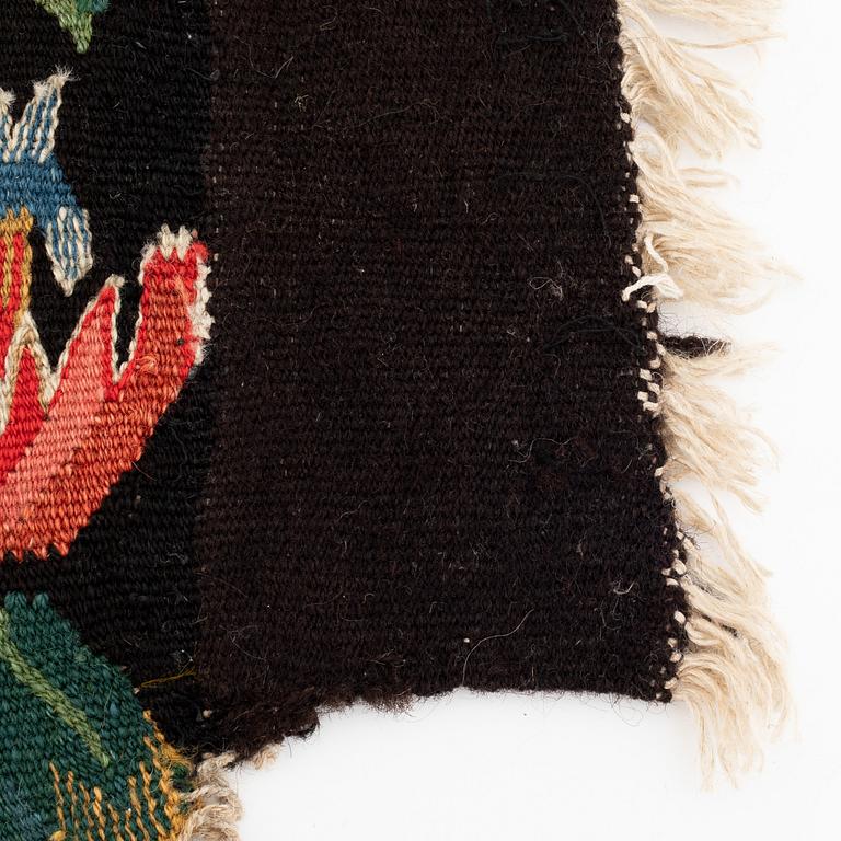 A fragment of a 19th century carrige cushion, "Urnor och par", tapestry weave, ca 50 x 45-55 cm.